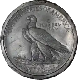 Une pièce de monnaie représentant un aigle, debout sur une branche et les inscriptions United States of America, E Pluribus Unum et Twenty Dollars.