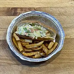 Pain à Hot-dog garni de salade accompagné de frites