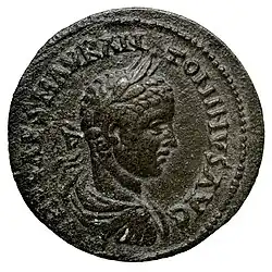 Pièce de monnaie représentant un jeune homme lauré en buste, avec des inscriptions autour.