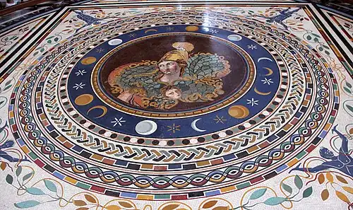 Mosaïque colorée composée de motifs circulaires, au centre la figure d'Athéna casquée surplombe le masque de Méduse.