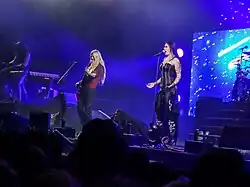 Image de trois membres d'un groupe de rock jouant sur une scène