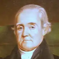 Portrait en buste d'un homme âgé aux cheveux blancs.