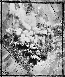 Photographie en noir et blanc d'un bombardement vue du ciel.
