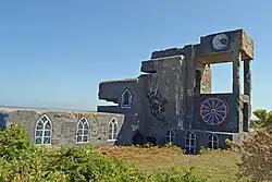 Vue d'un blockhaus de plusieurs étages. Des vitraux ont été peints pour figurer une église.