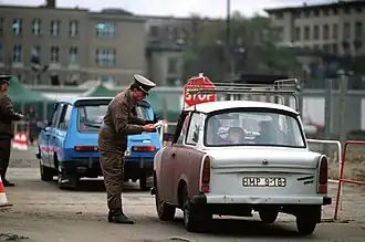 Une Trabant 601 S passant le mur de Berlin le 14 novembre 1989.