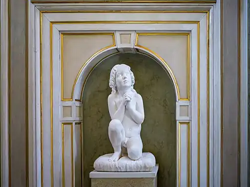 Kneeling child at prayer in the Palazzo Tosio, Brescia