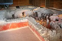 vue de murs antiques conservant des traces de peinture rouge.