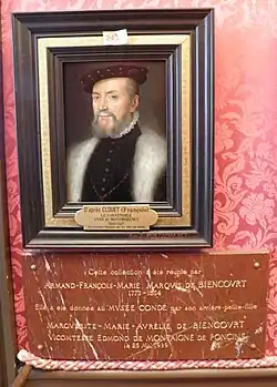 Plaque de marbre rouge surmontée d'un petit portrait peint placé sur une tenture rouge