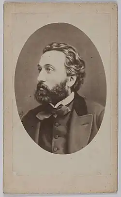 Portrait photographique d'un homme barbu.