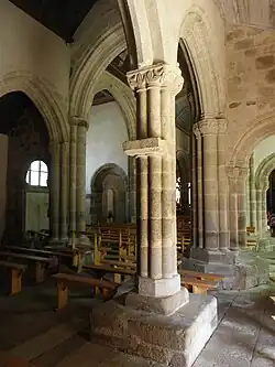 Le pilier polylobé entier, de l'arcade au banc de pierre. En arrière-plan, la croisée du transept.