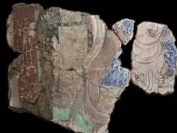 Couple richement paré. Scène de la prédication du Bouddha. Kucha, Duldur-āqur, sanctuaire du nord-est. Xinjiang. Peinture murale, début du VIe&nbsp;siècle. Musée national des Arts asiatiques - Guimet, Paris.