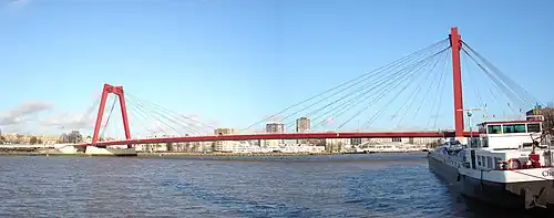 pont rouge sur une rivière avec une péniche