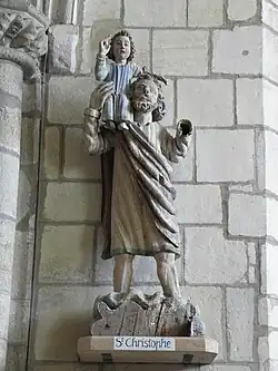 Photographie d'une statue de saint portant un enfant sur son épaule.