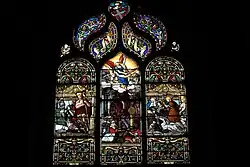 Photographie d'un vitrail représentant l'Enfer entre deux donateurs.