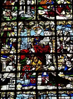 Élément de vitrail. Au centre de l'image, une femme habillée en rouge lit. Des hommes sont agenouillés à ses pieds. Des phylactères sont visibles.