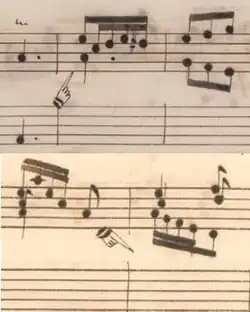 zoom sur les partitions de Venise et Parme montrant de petites mains dont l'index est dirigé soit vers le haut, soit vers le bas, indiquant le changement de clavier