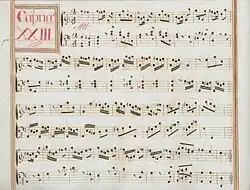 partition manuscrite rehaussée de couleurs passées, rouge et vert en bordures et cadre de titre, titre en rouge