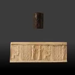 Sceau-cylindre avec son impression, représentant une scène de présentation d'un homme devant une divinité. V. 1850-1700 av. J.-C., musée des beaux-arts de Lyon.