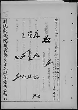 Photo noir et blanc de signatures sur une page d'un texte de loi écrit en japonais, noir sur fond blanc.