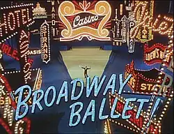 Décor de Times Square illuminé. Au centre, dans les feux des projecteurs, un homme est debout les bras écartés. En majuscules et en grosses lettres bleues, le texte Broadway Ballet.