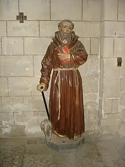 Statue de saint Antoine et son cochon, collégiale d'Uzeste en Gironde.