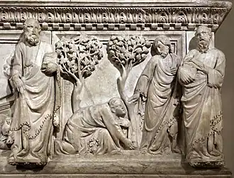 Panneau sculpté en bas et haut-relief représentant deux arbres et quatre hommes dont un agenouillé