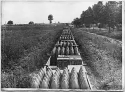 Photo noir et blanc d'un petit train rempli d'obus.