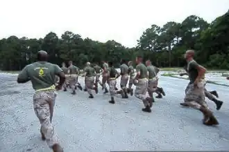USMC Gunnery Sgt. leads his Marines on a run to the obstacle course 2011.