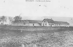 Photo noir et blanc d'une petite usine à toit de sheds.