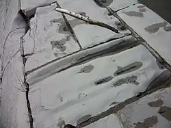 Lors des crues, le fort courant laisse des traces visibles sur le parement de pierre du barrage