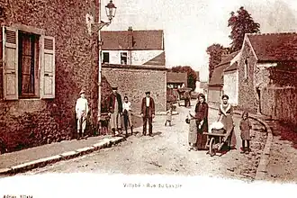 Vue d'une rue avec des adultes et des enfants. Carte postale ancienne.