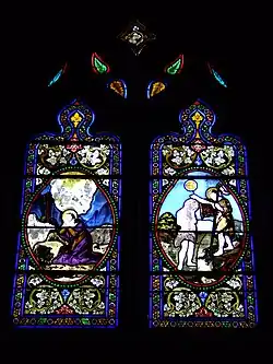 Vitrail latéral nord représentant à droite le baptême du Christ dans le Jourdain et à gauche sainte Marie-Madeleine près du corps de Jésus au lieu-dit Golgotha appelé également le Calvaire (Mt 27, 33.61).