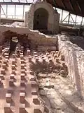 Tepidarium 1 avec son hypocauste, le petit frigidarium au fond