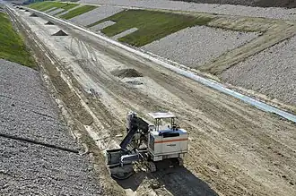 Travaux de terrassement d'un fossé à Poullignac. en 2014.