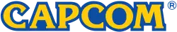 Logo de l’entreprise avec les caractères Capcom en jaune sur fond bleu.