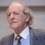 portrait photographique en couleurs d'un homme grisonnant vu de trois-quarts gauche